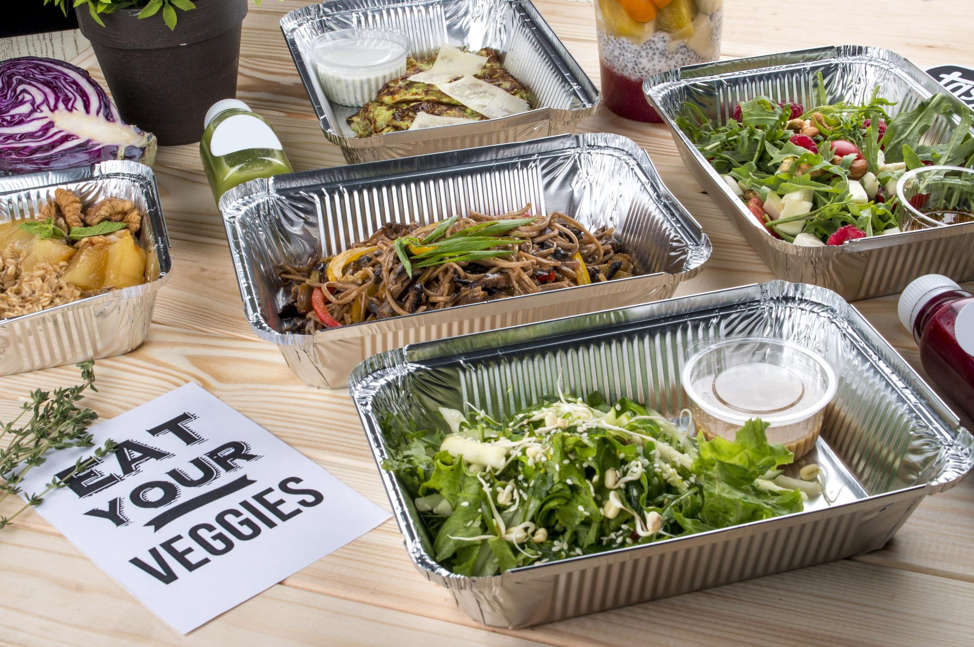 stack of to-go meal trays neatly labeled